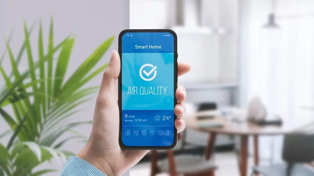 Woman checking air quality in her home using using a smartphone