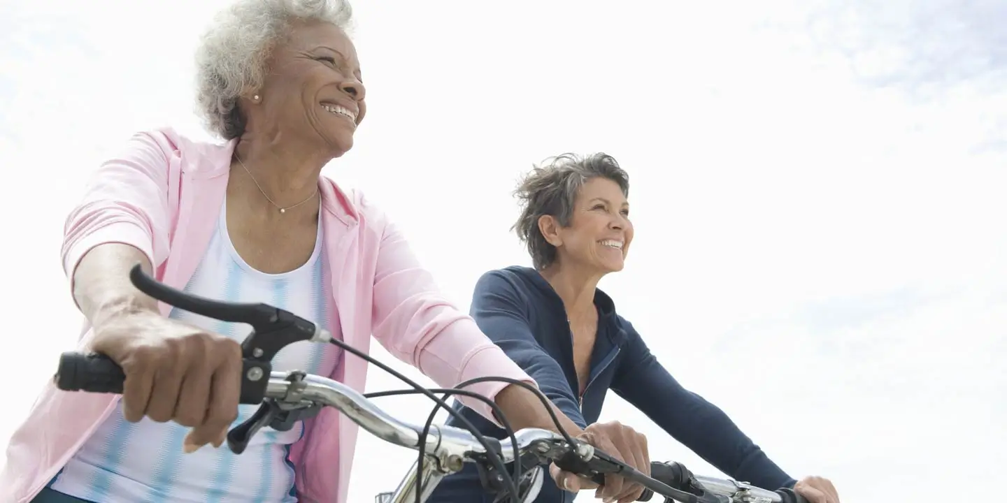 Happy seniors enjoying a beautiful day riding their bikes.