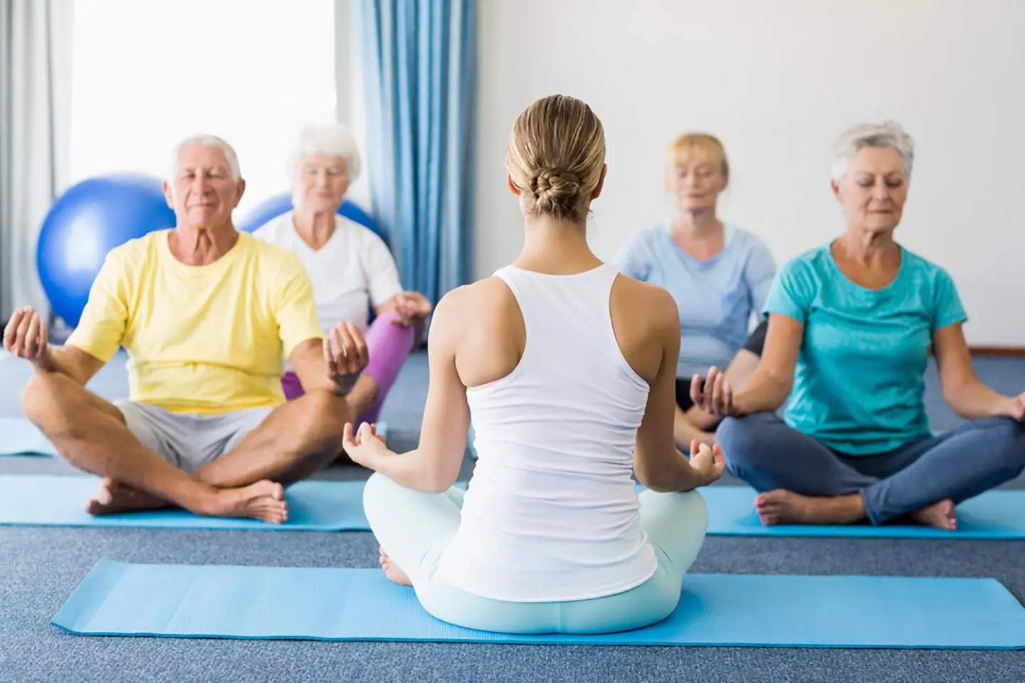 Seniors participating in a yoga class.