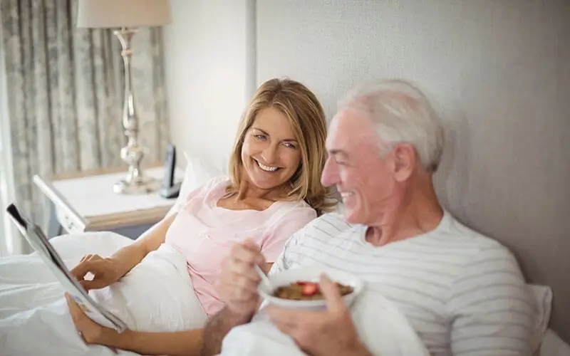 Smiling couple spending a morning reading a magazine