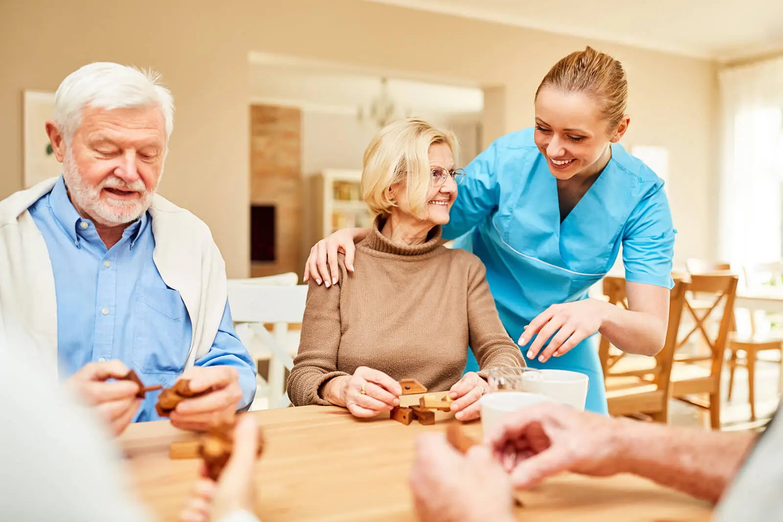 Happy seniors playing a block game, while getting help from a young girl.