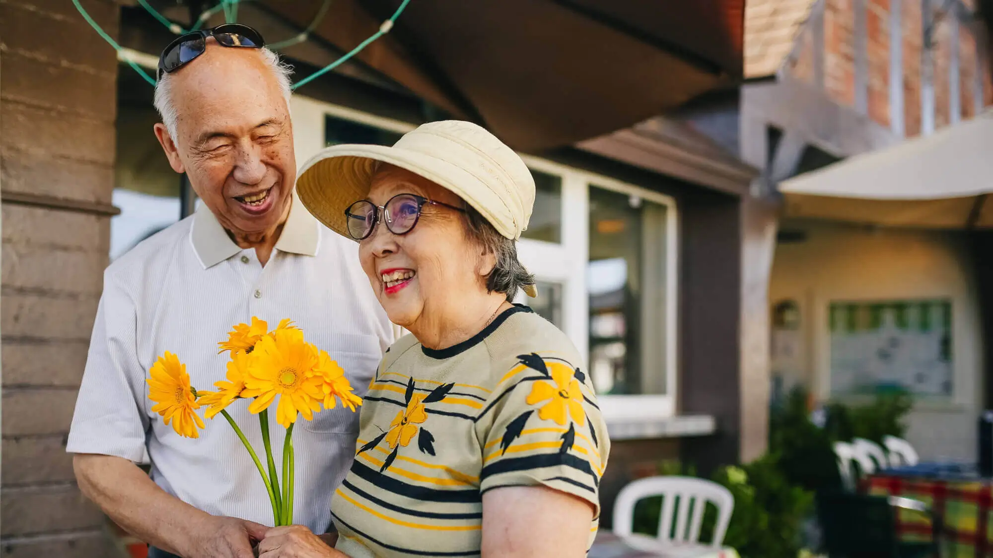 Elderly Couple Holding Bouquet of Flowers while Holding Hands