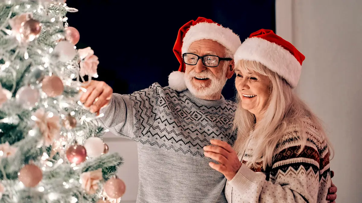 senior decorating christmas tree together