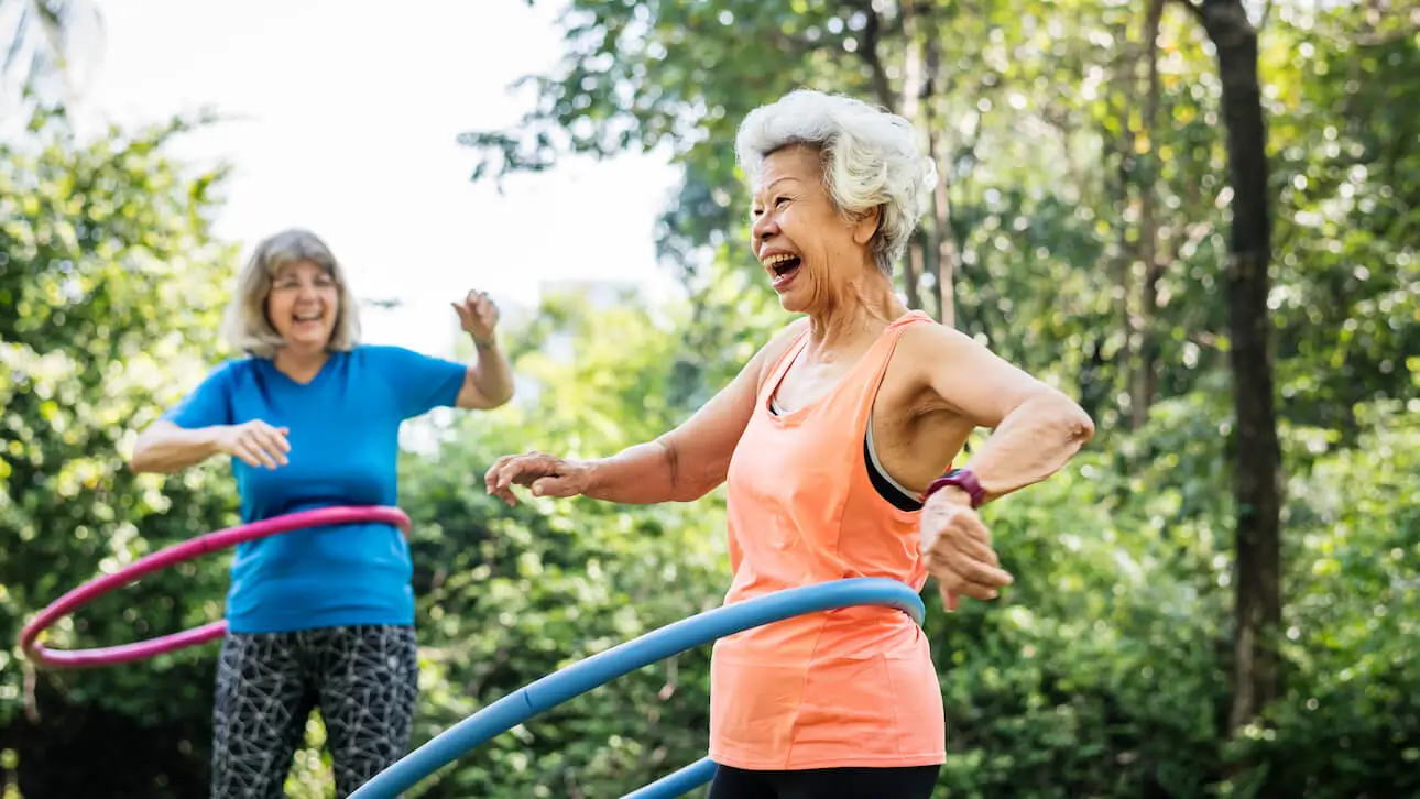 Senior woman exercising with a hula hoop