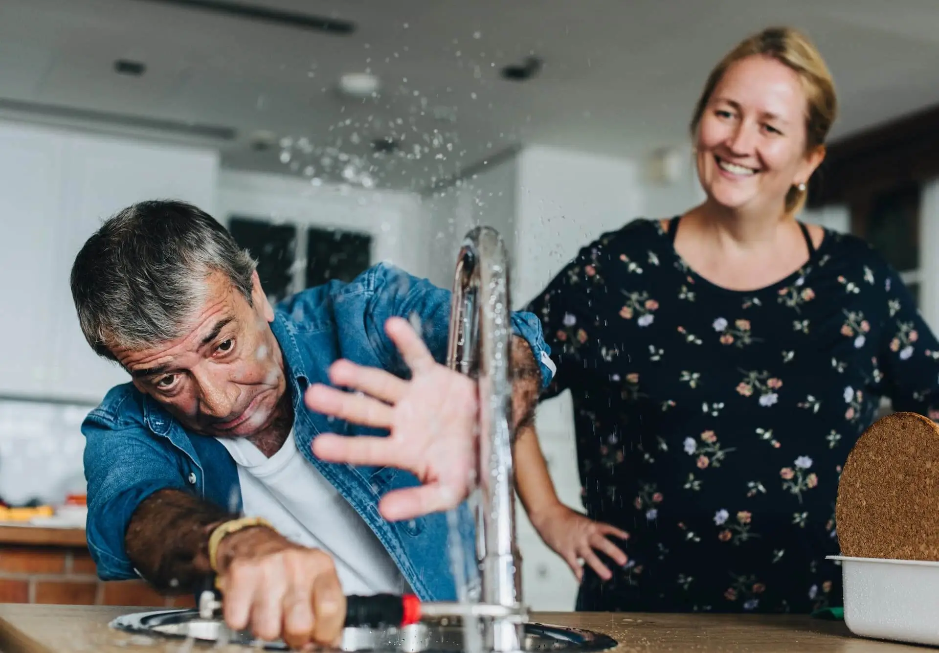 Couple fixing a kitchen sink