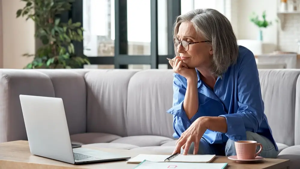 Senior mature older woman watching business training, online webinar on laptop computer remote working or social distance learning from home. 60s businesswoman video conference calling in virtual chat