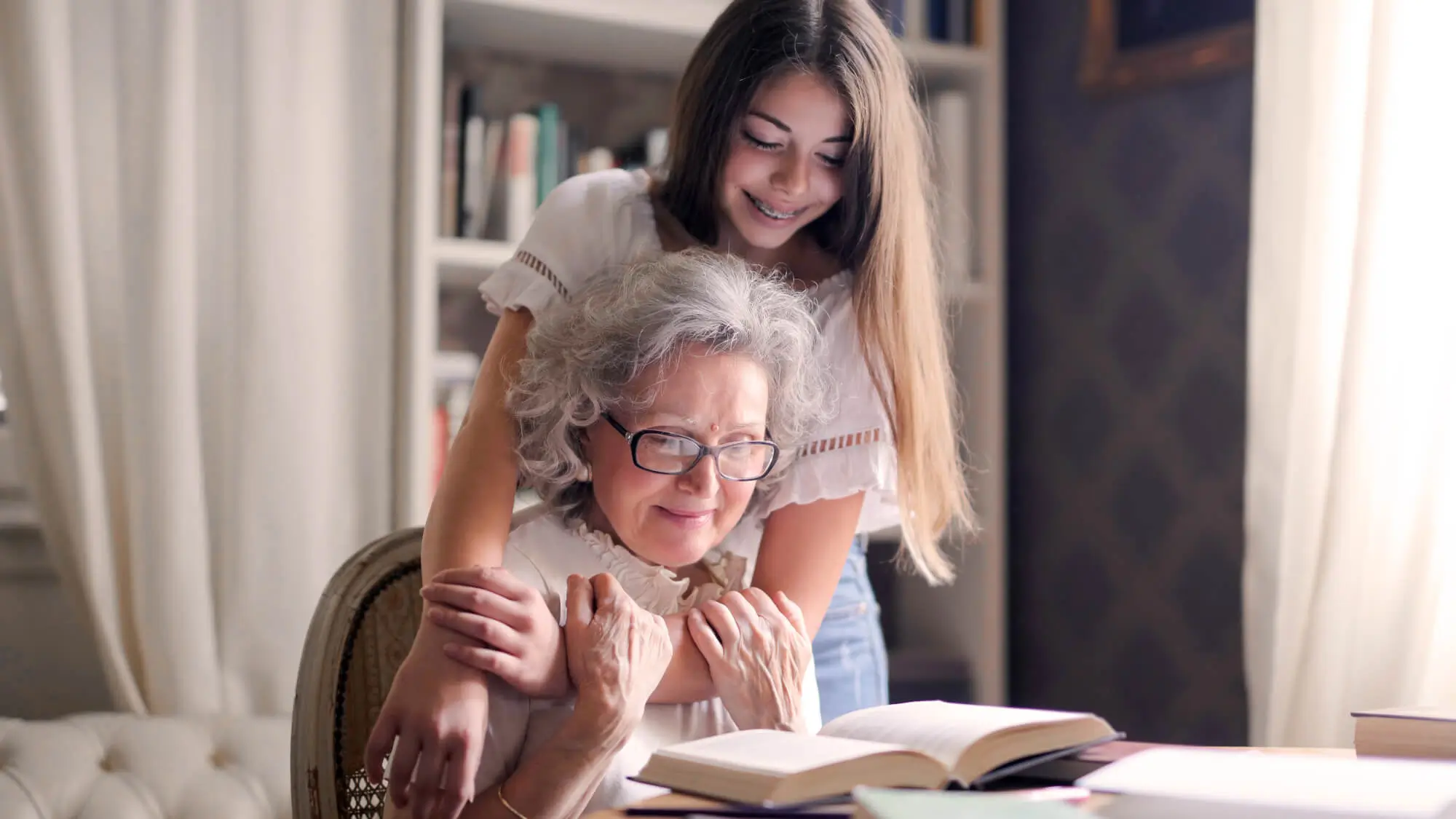 Grandma and granddaughter studying together