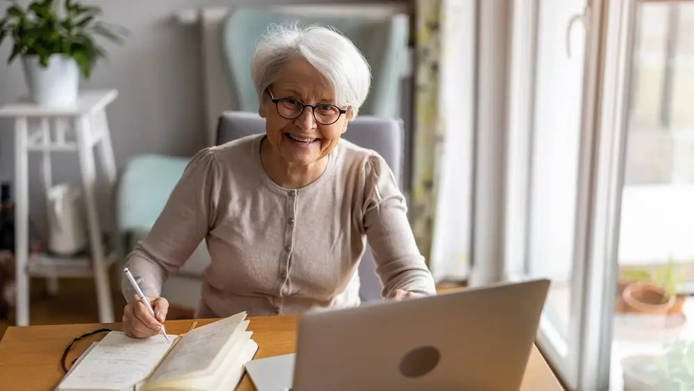 Senior woman using laptop at home