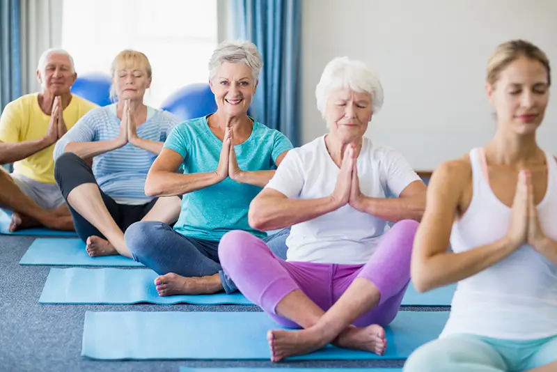 Seniors enjoying their yoga class.