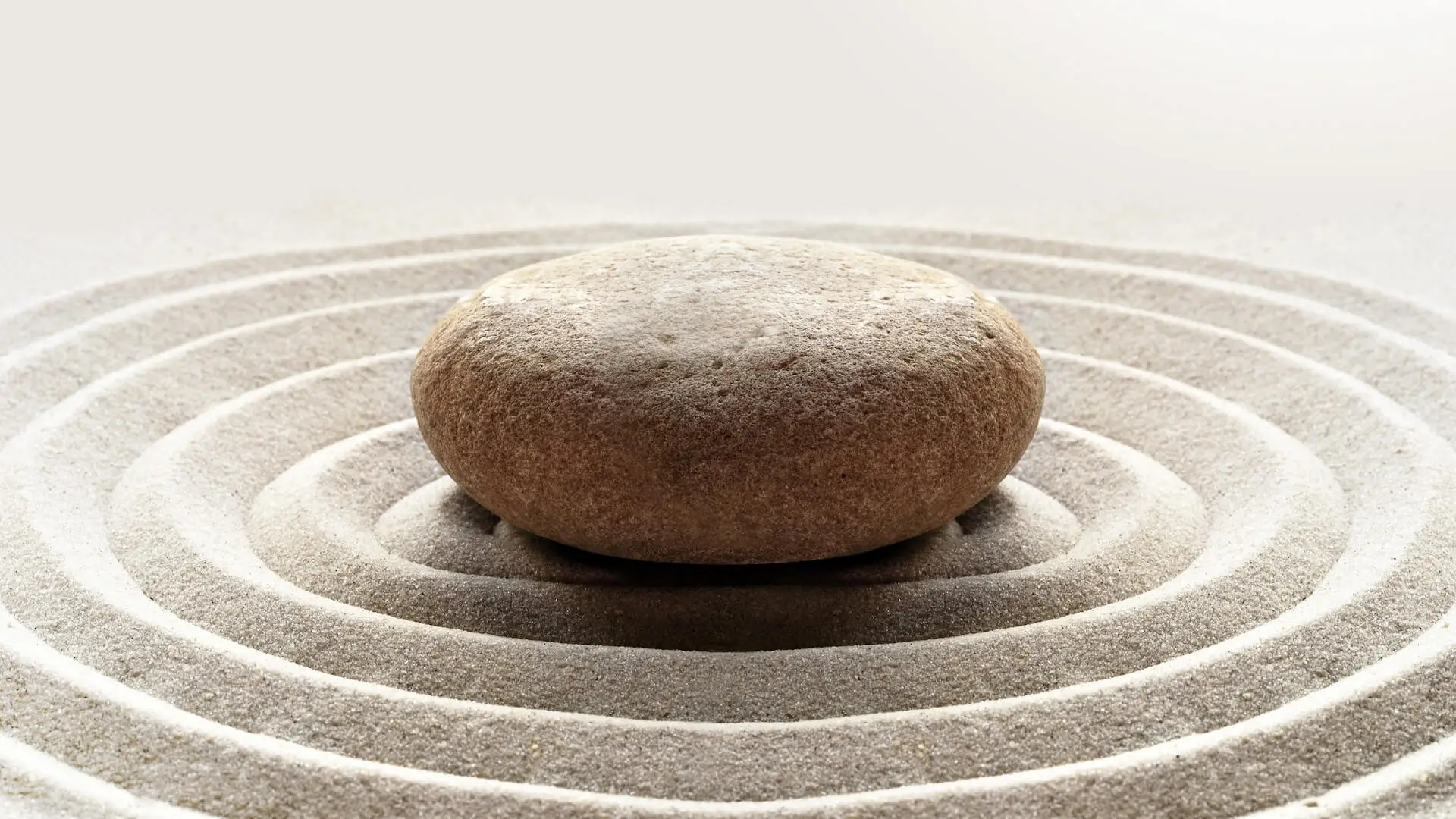 zen garden meditation stone background with stones and lines in sand for relaxation balance and harmony spirituality or spa wellness.