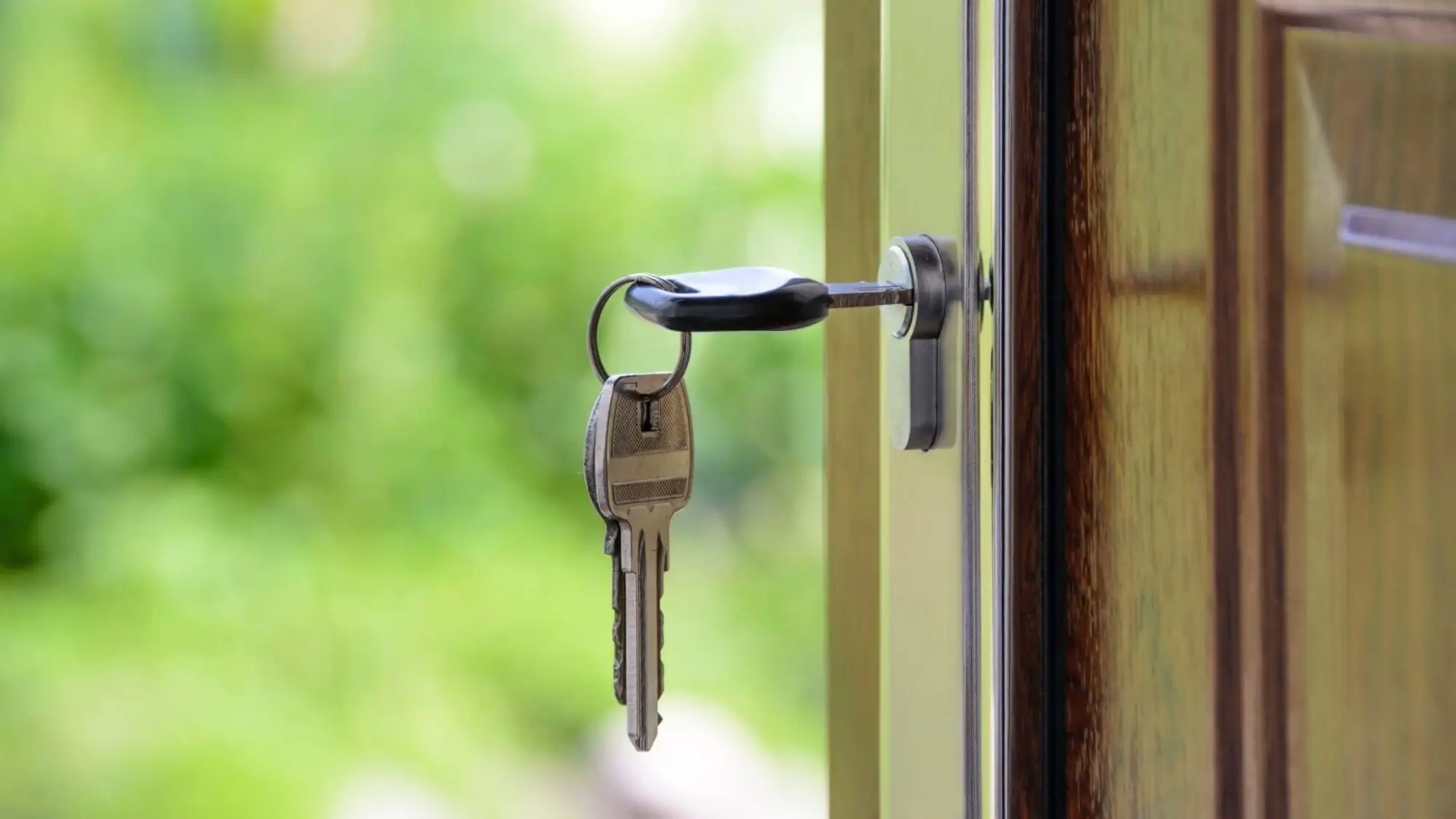 Set of keys unlocking front door of house