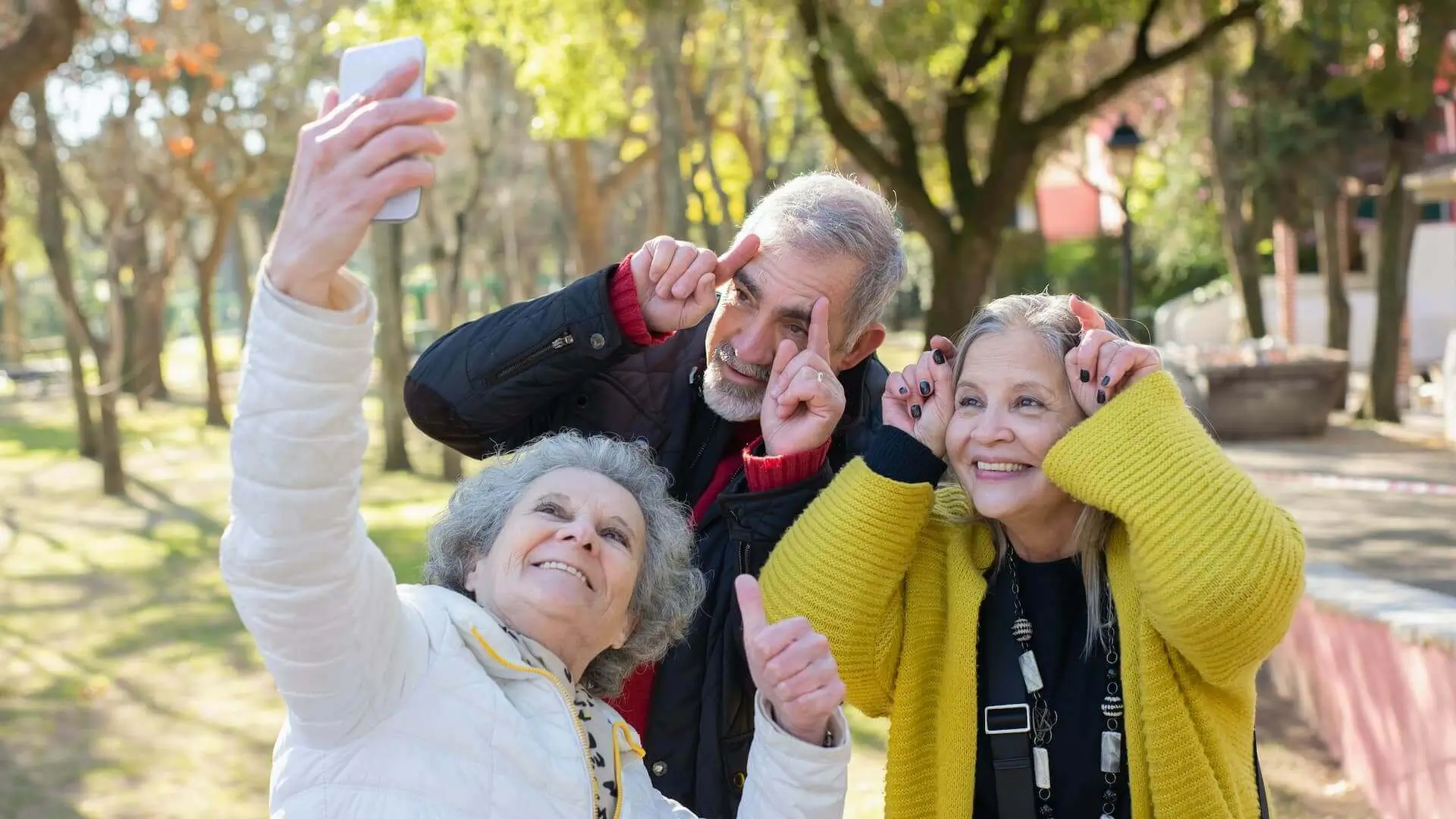 Three Elderly People Taking Group Selfie
