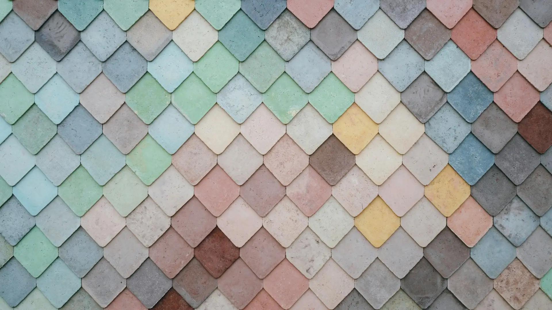 a multicolored tile wall with a pattern of small squares
