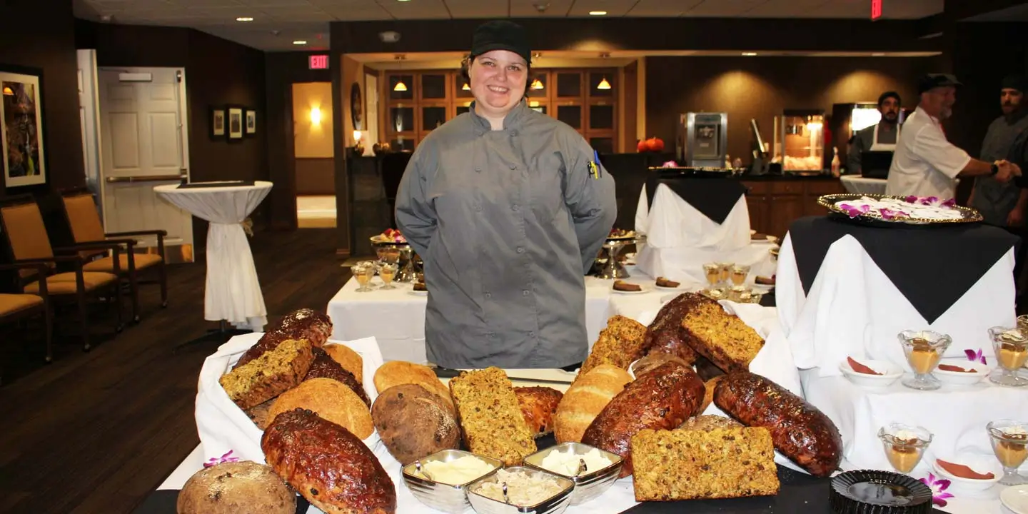 Chef Emily showing off her display of bread at Resort Lifestyle Communites.