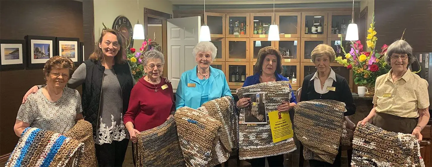 Residents showing off their quilts at Daniel Pointe.