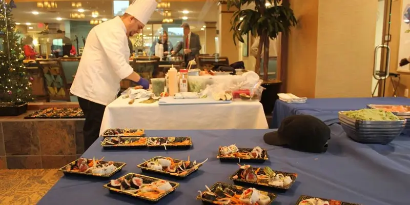 A culinary team chef preparing sushi for the residents of Resort Lifestyle Communities.