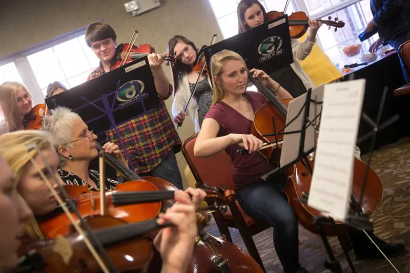 Senior joined a class of young individuals to play their violins and violas.