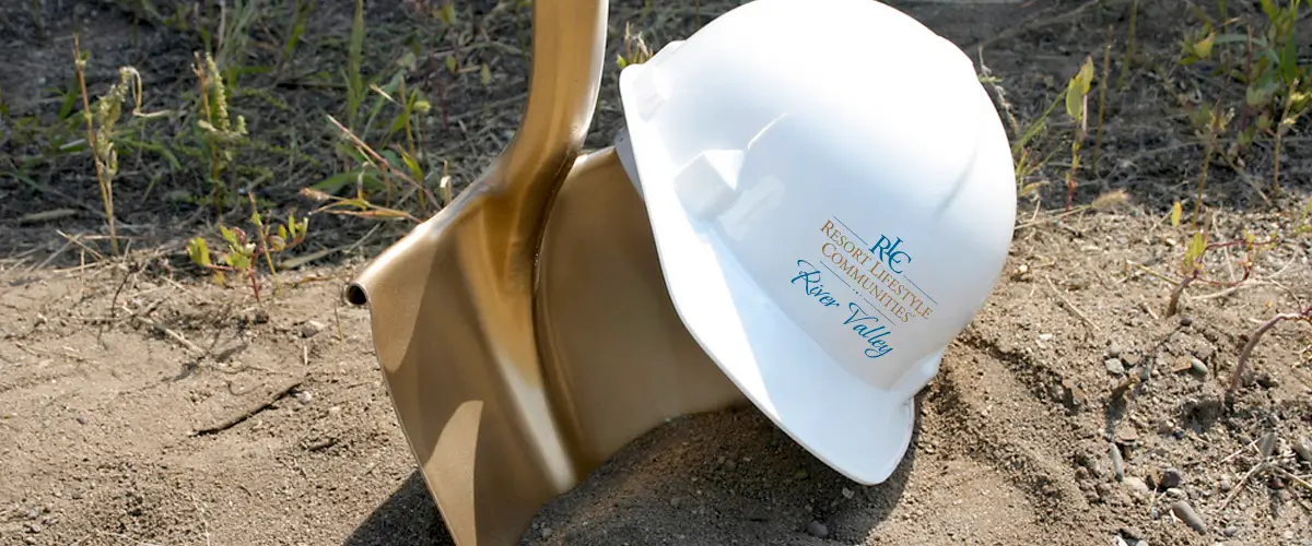 Golden shovel and Resort Lifestyle Communities hard hat to represent the construction being done at River Valley.