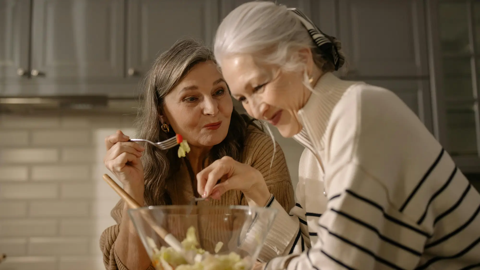 An Elderly Women Eating Salad in the Kitchen