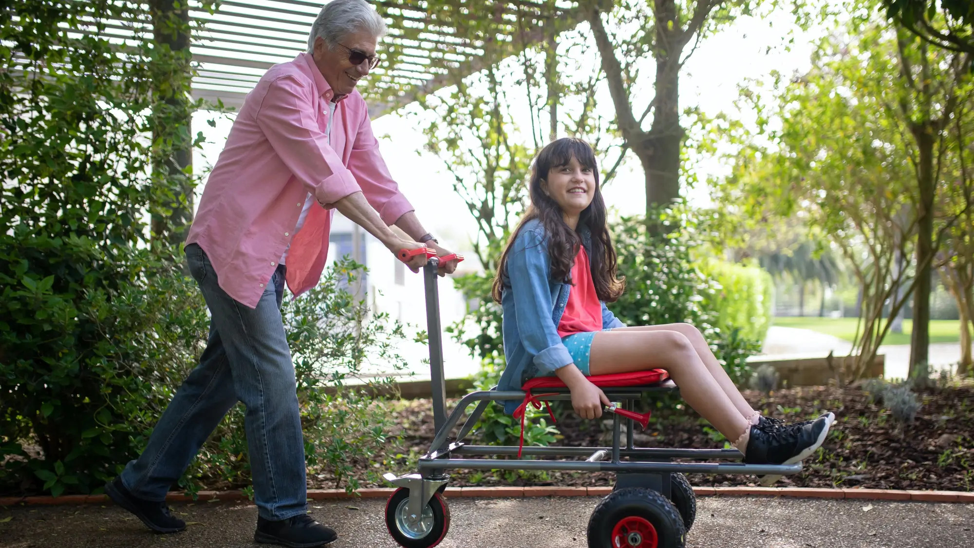 An Elderly Man Bonding with his Granddaughter at a Park