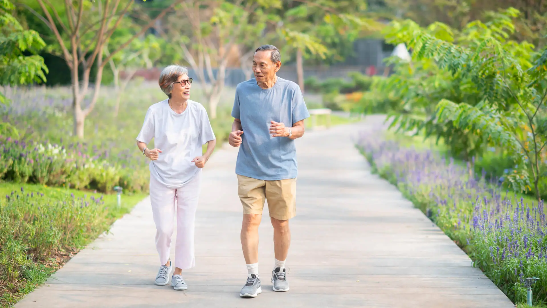 Asian senior retired couple jogging or exercise in the park. Healthy elderly people concept