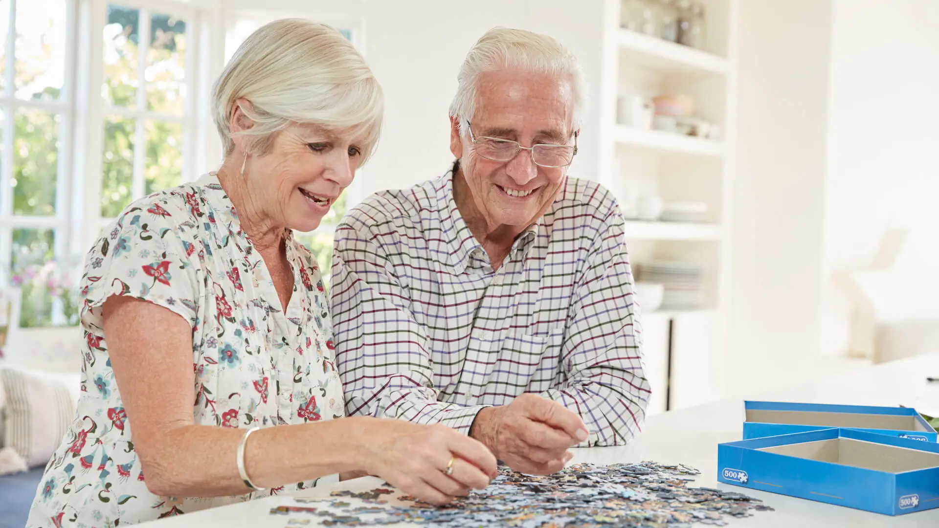 Senior couple doing a jigsaw puzzle at home