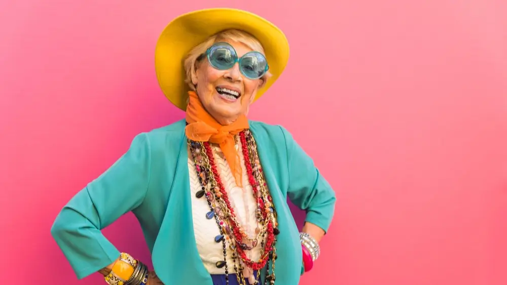 Happy and playful senior woman having fun - Portrait of a beautiful lady above 70 years old with stylish clothes, concepts about senior elderly people