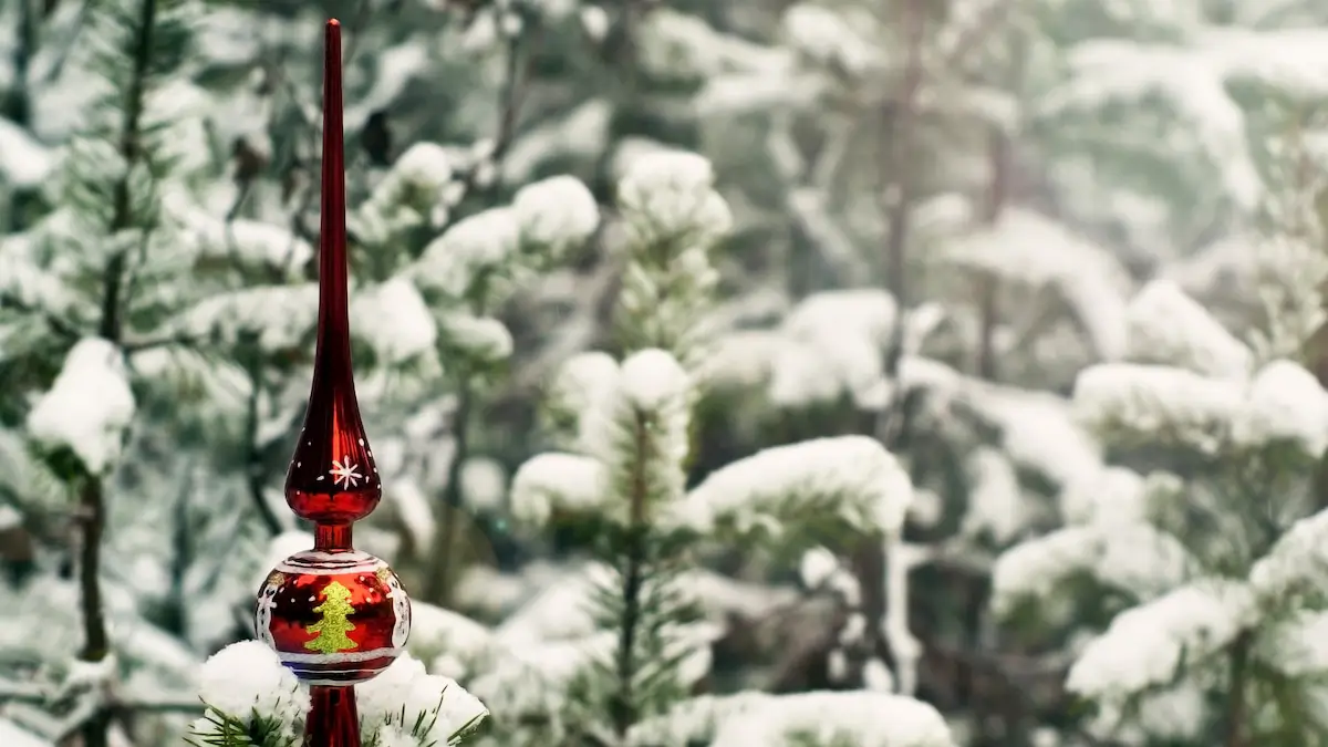 vintage christmas tree topper in a snow-filled pine forest
